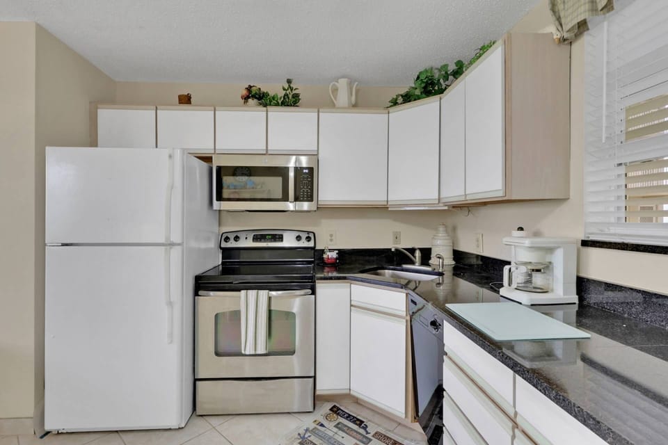 The kitchen is equipped with oven, microwave, refrigerator/freezer and compact dishwasher.
