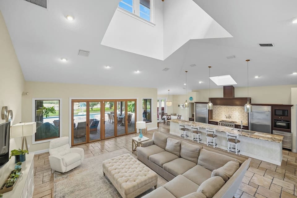 Spacious living room glowing w/ skylights