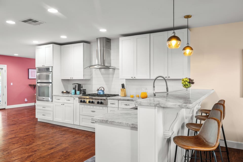 Bright, modern kitchen with bar seating—perfect for morning coffee or cooking together.
