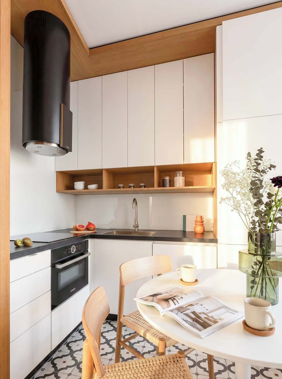 A modern, fully equipped kitchen with sleek cabinetry, quality appliances, and a cozy dining area.