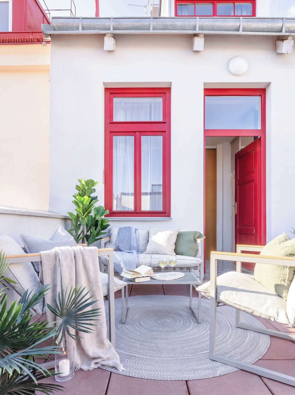 Outdoor seating area on the private terrace, furnished with comfortable chairs and greenery.