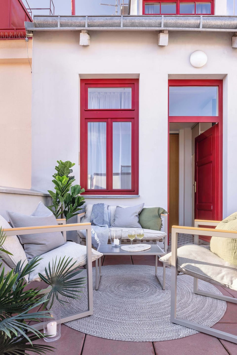 Cozy outdoor seating area on the private terrace, furnished with comfortable chairs and greenery. A perfect spot to relax in the fresh air and enjoy a quiet moment outside.