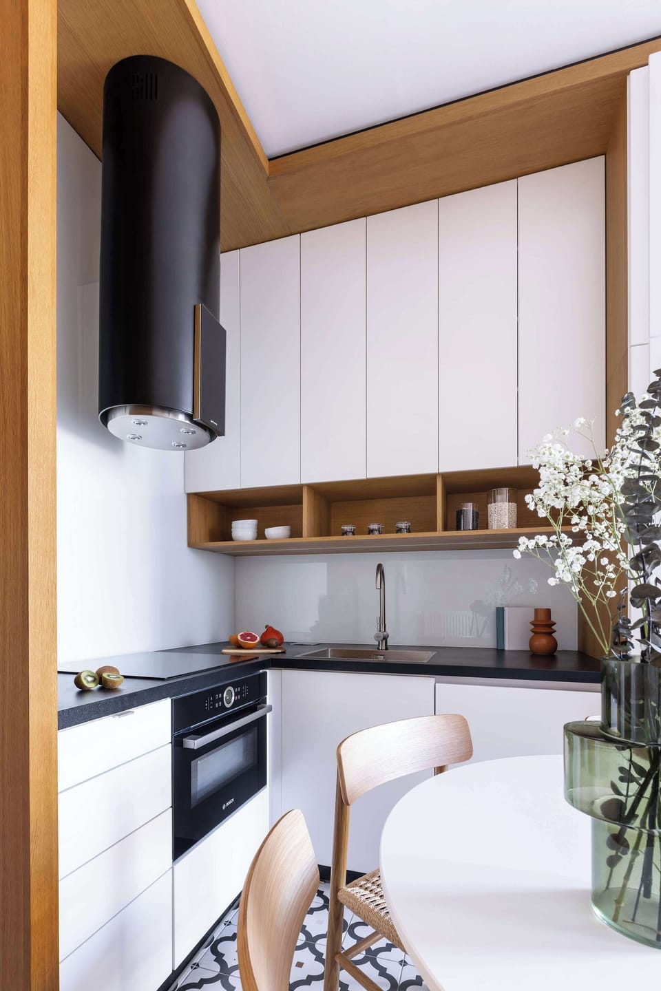A modern, fully equipped kitchen with sleek cabinetry, quality appliances, and a cozy dining area. Perfect for preparing meals or enjoying a relaxed breakfast at home.