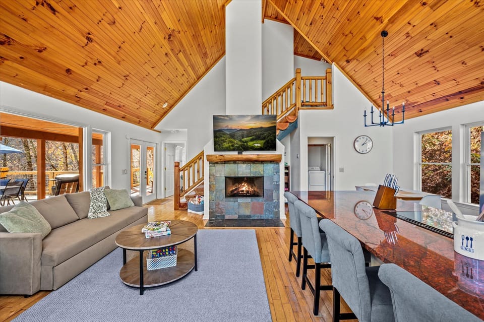 Vaulted ceilings, stone fireplace, and mountain views in the living room.
