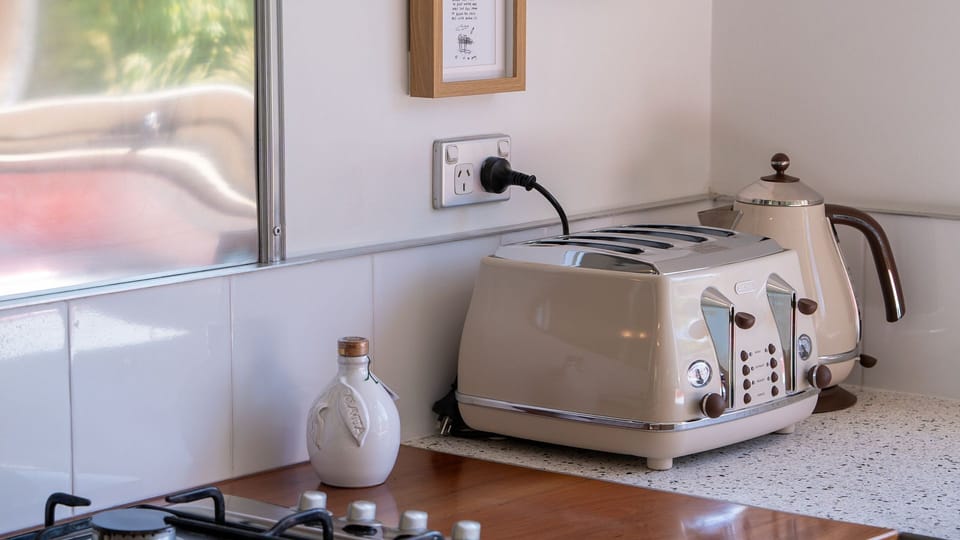 Compact kitchenette setup with toaster and essentials.