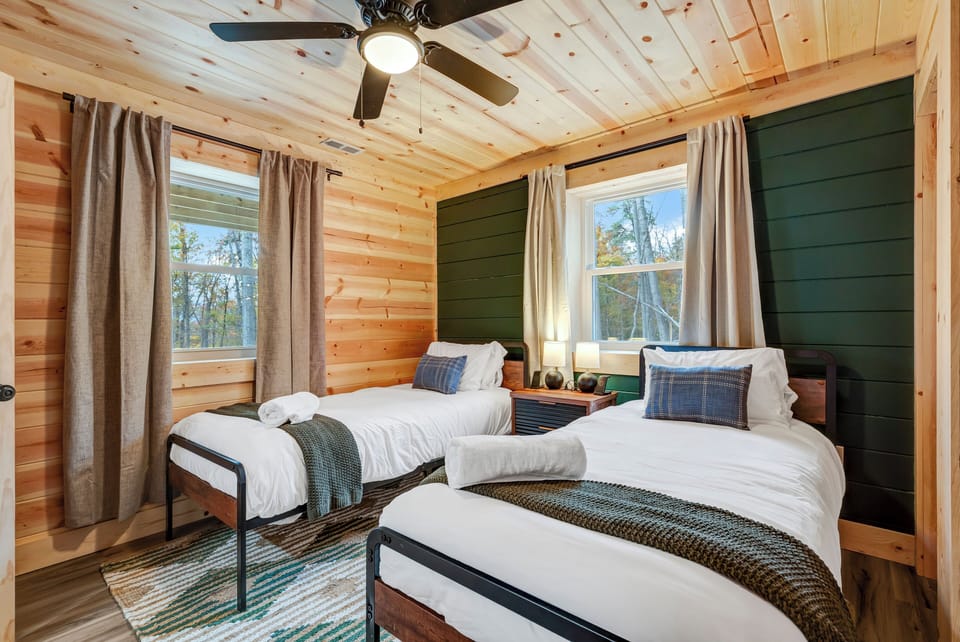 Bright and cozy bedroom with two Twin XL beds, soft linens, and fresh towels.