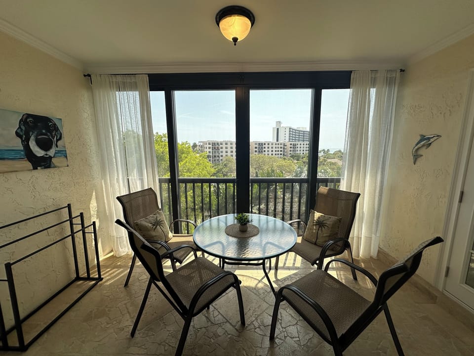 Your private balcony dining spot overlooks leafy surroundings, perfect for morning coffee or evening meals with city views.