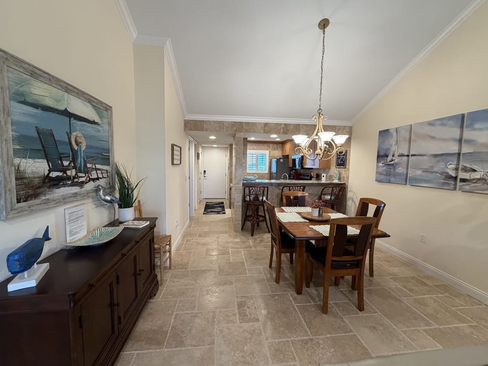 You'll love gathering around this beautiful dining table with coastal artwork creating a serene atmosphere for your meals together.