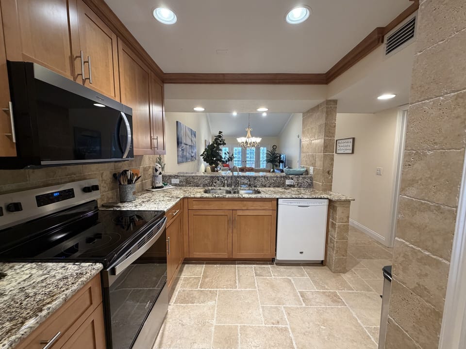 Your fully equipped kitchen features granite countertops, modern appliances, and an open layout that flows seamlessly into the dining area.