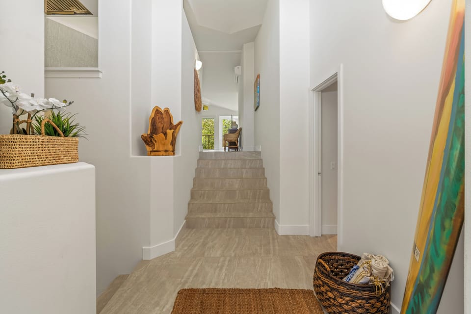 Clean, airy hallway connects the living area with the tranquil bedrooms.