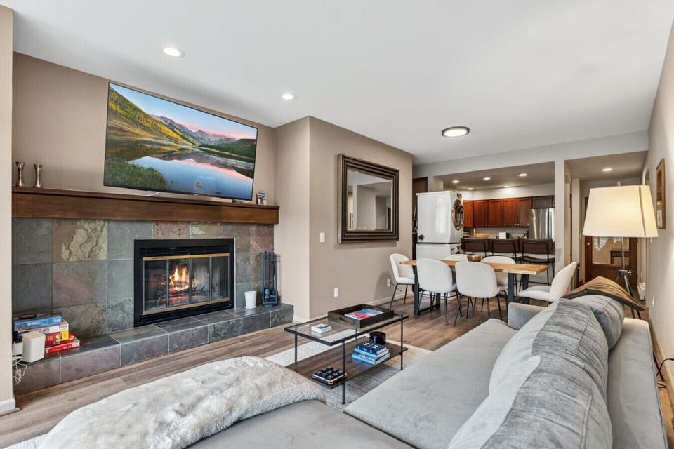 Spacious living room with fireplace, smart TV, and gorgeous views
