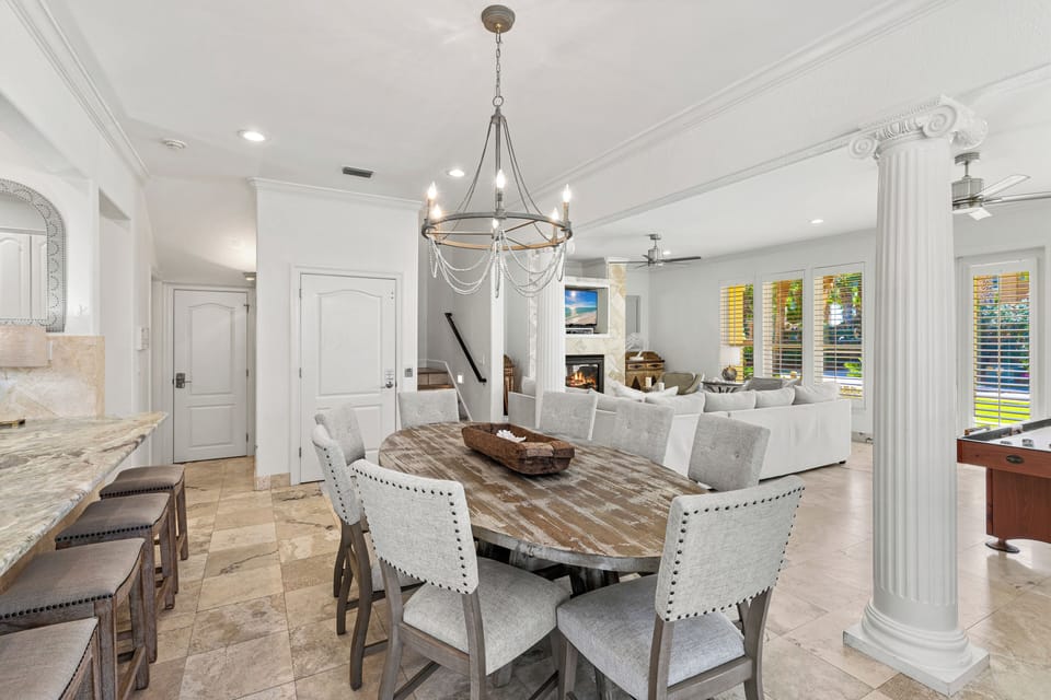 Your elegant dining space flows seamlessly into the living area, perfect for memorable meals under stunning chandelier lighting.