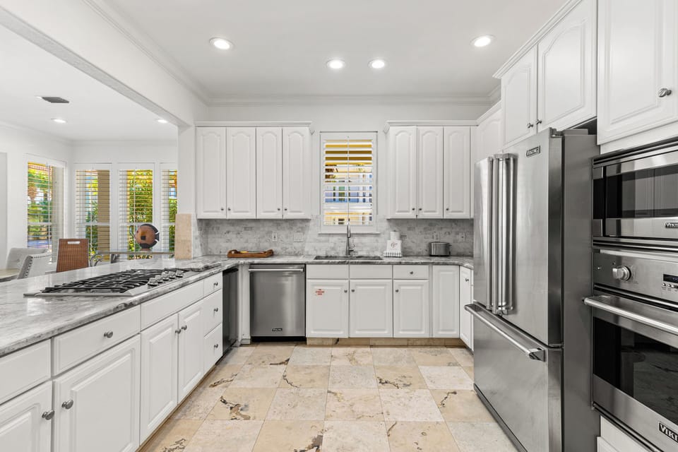 Cook with ease in your fully equipped gourmet kitchen featuring premium appliances and elegant marble countertops.