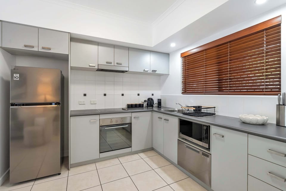 Prepare easy meals in the main apartment's kitchen fitted with modern appliances, including a full-size fridge, oven, stovetop, dishwasher, and all essential cookware.