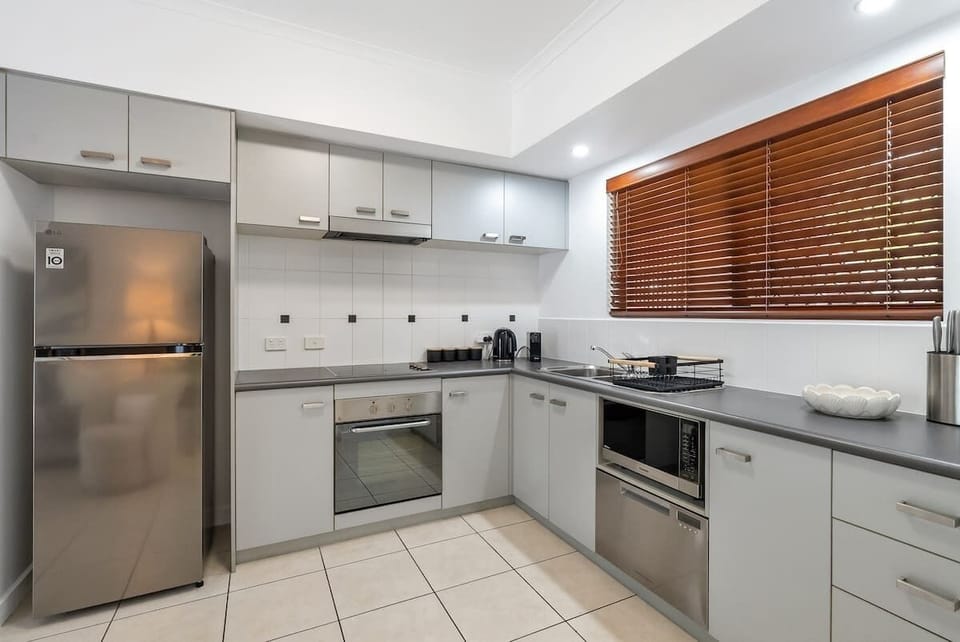 Prepare easy meals in a full kitchen fitted with modern appliances, including a full-size fridge, oven, stovetop, dishwasher, and all essential cookware.