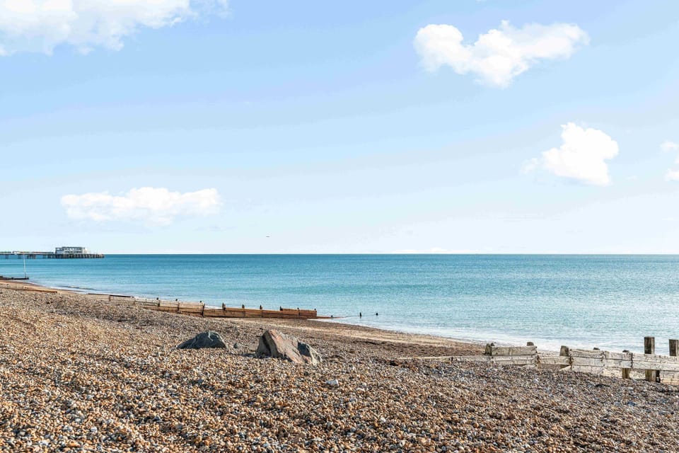 Apartment in a prime seafront location with bright coastal decor and sweeping sea views from the living space.