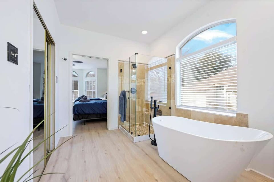 Primary full bathroom with luxurious tub and shower attached to primary bedroom downstairs 