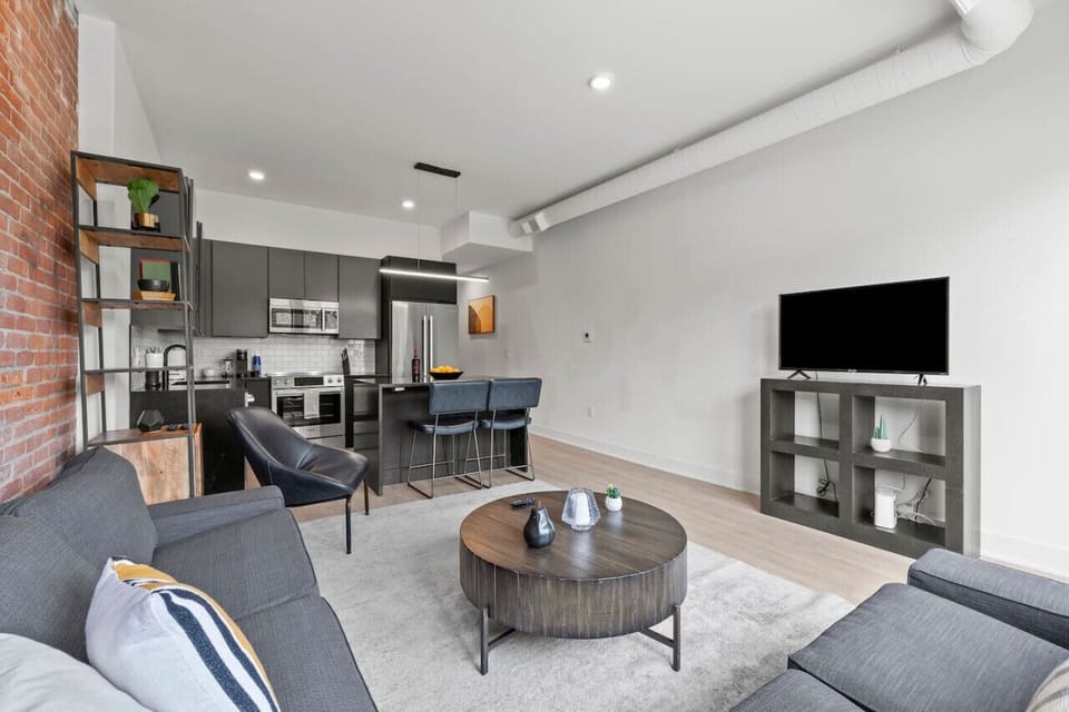 A bright and inviting living room featuring comfortable seating and a smart TV for your entertainment.