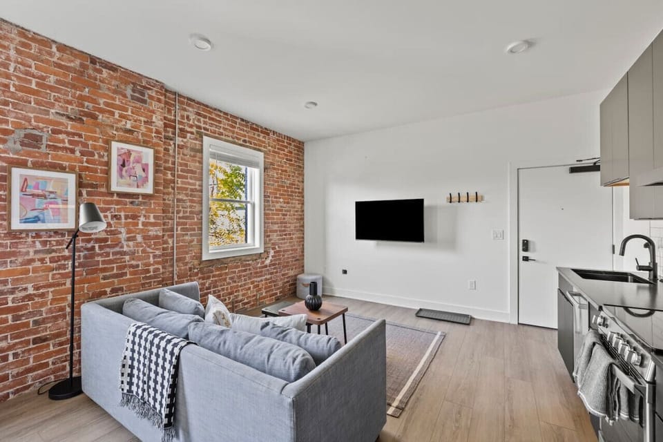 Spacious and bright living room featuring comfortable seating and modern decor.