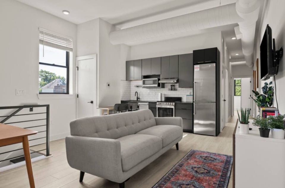 Relax in our bright, open-concept living room featuring comfortable seating and a smart TV for movie nights.