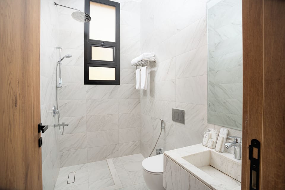 Shower, hair dryer, slippers, towels