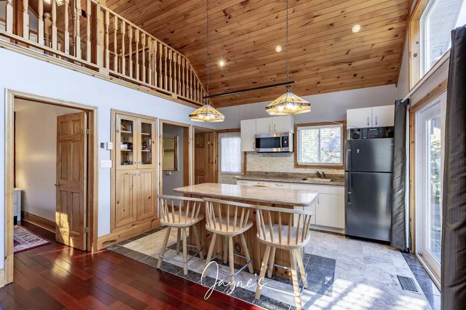 Cozy kitchen with vaulted ceilings and breakfast bar seating