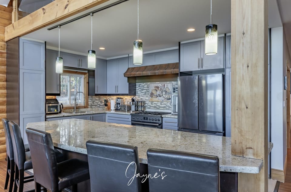Modern kitchen with sleek appliances and spacious island seating