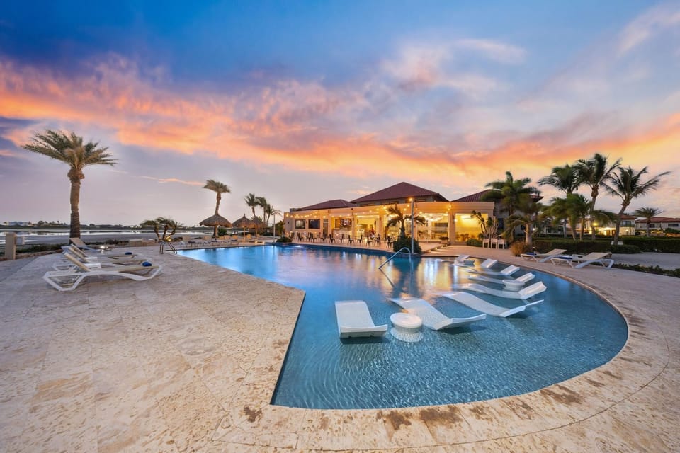 Twilight brings a tranquil glow to the pool area, making it the perfect backdrop for a romantic evening or a cozy family gathering.