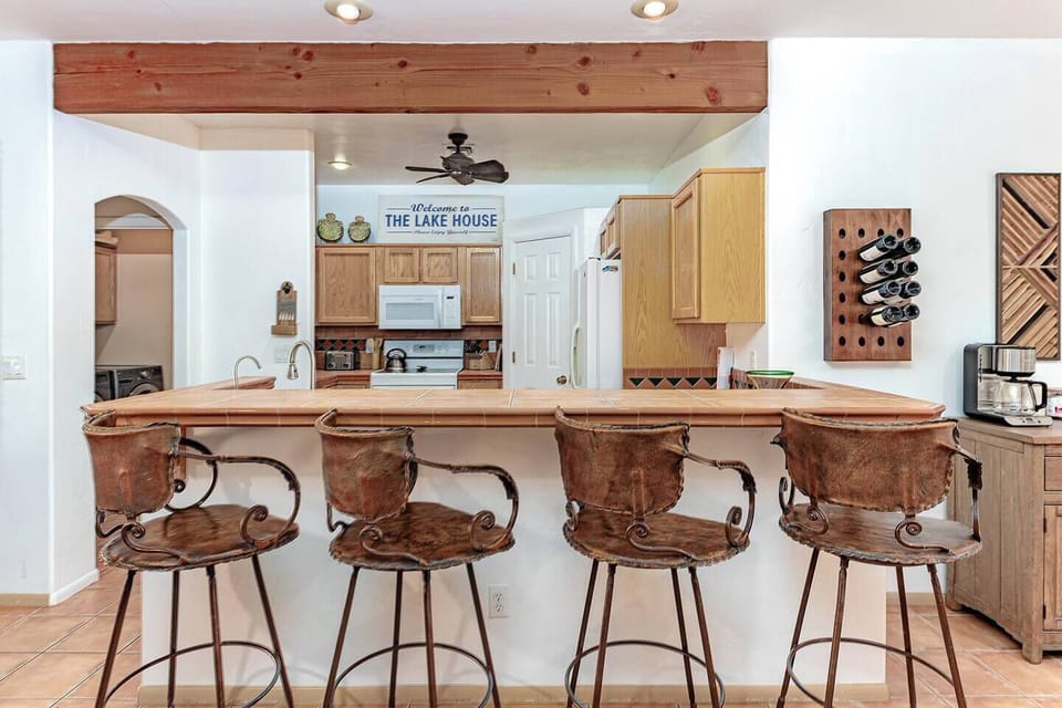 Relax under the covered patio with firepit, lounge seating, and poolside ambiance.