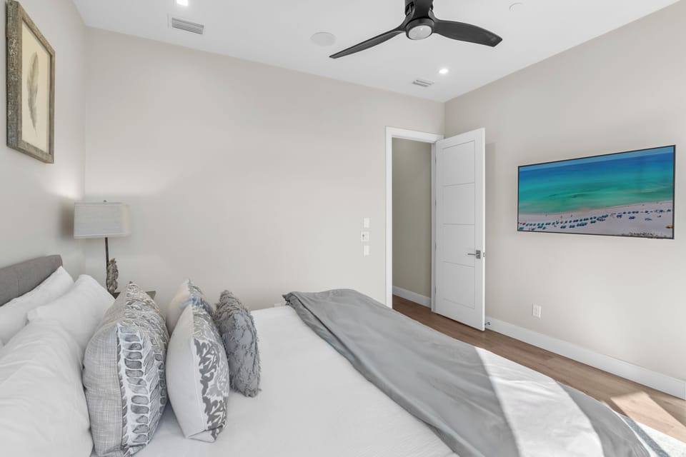 The primary bedroom features a king bed, TV, balcony, and an ensuite bathroom. (2nd floor)
