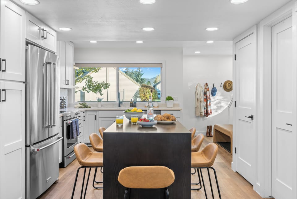 Open-concept kitchen and dining area with island seating.