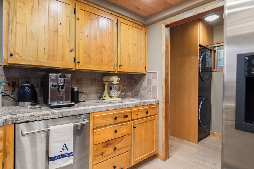 The laundry area can be accessed through the kitchen.