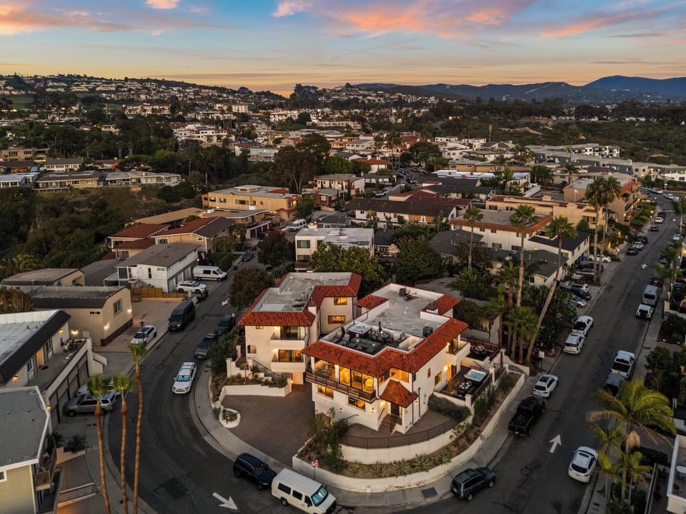 Aerial view of neighborhood homes near the ocean.