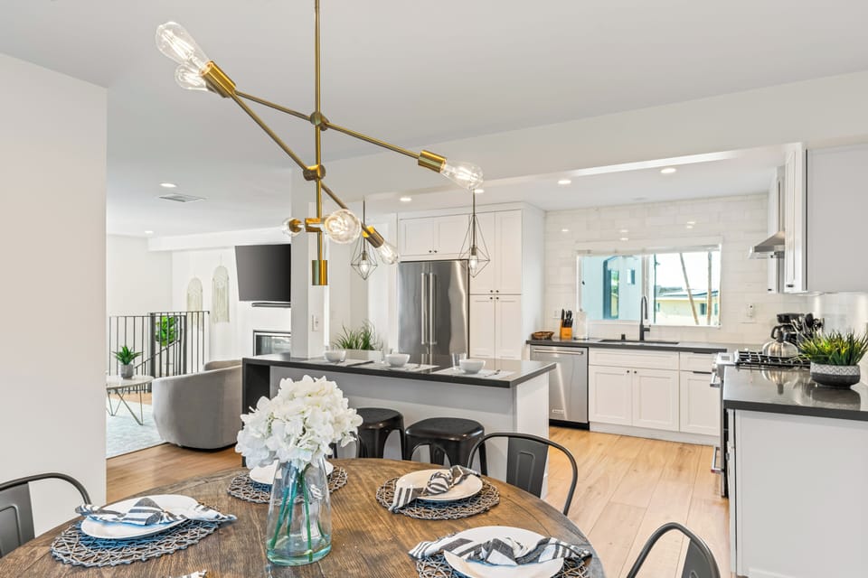Open-concept kitchen and dining area with modern lighting.