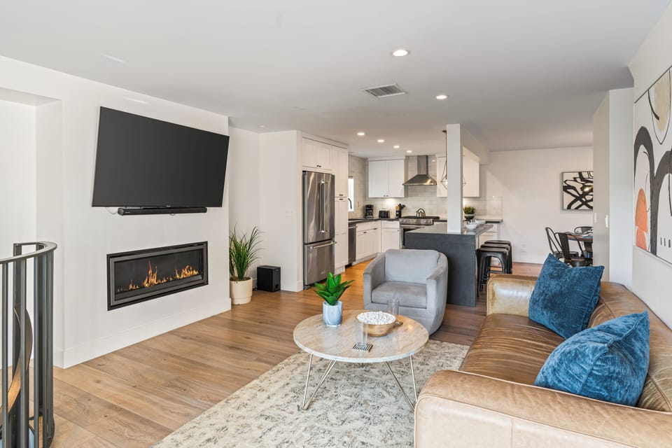 Modern living room with fireplace and cozy seating area.
