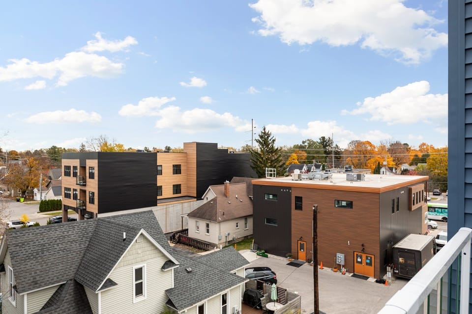 Elevated neighborhood views w/ treetops & surrounding rooftops.