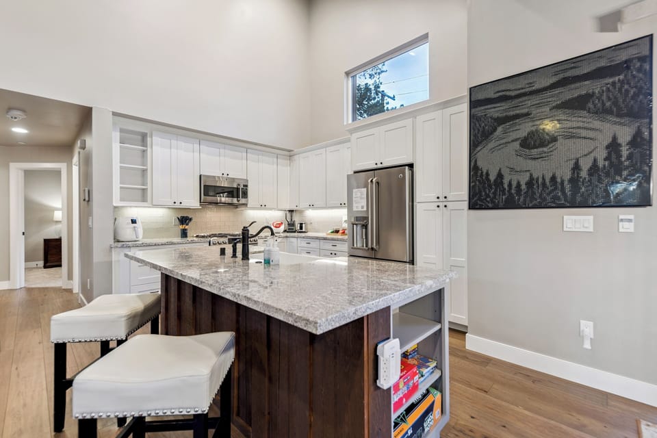 Your fully equipped kitchen features granite countertops, stainless steel appliances, and a spacious island perfect for meal prep and casual dining.
