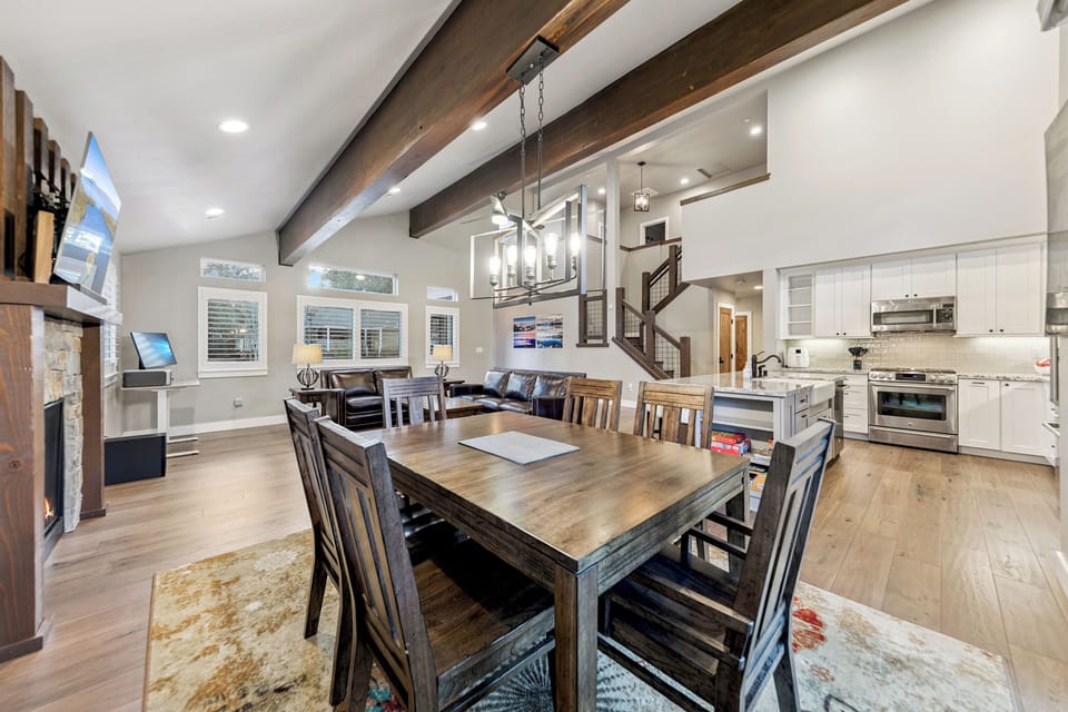 Gather around this stunning dining table where rustic beams meet modern elegance, creating the perfect space for memorable meals together.