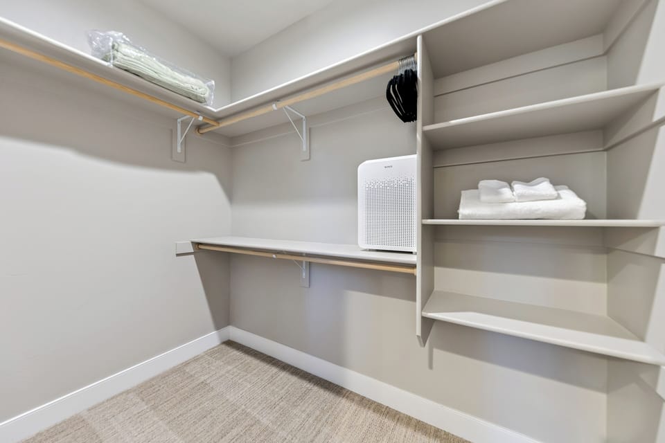 Your spacious walk-in closet features custom shelving, hanging rods, and an air purifier to keep your belongings fresh during your stay.
