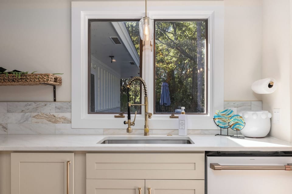 Windows above the sink make it easy to keep an eye on the family
