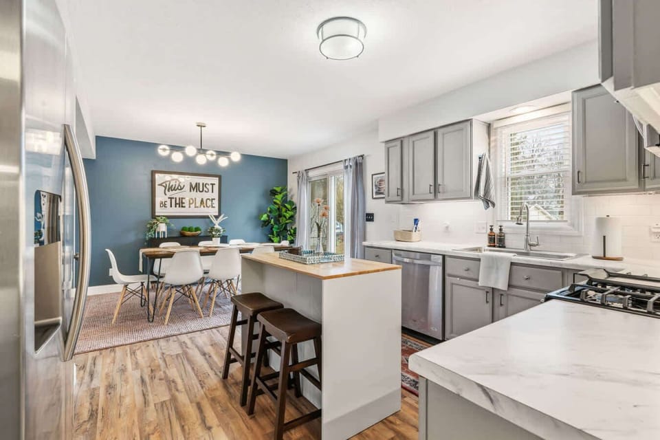 Spacious kitchen w/ large island, pendant lighting & plenty of prep space.