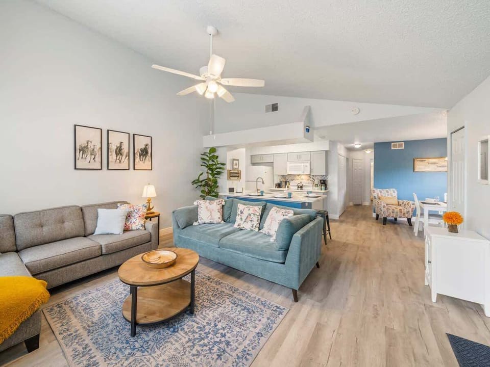 The seamless flow between the living room, dining area, and kitchen creates a bright, airy space designed for connection and comfort.