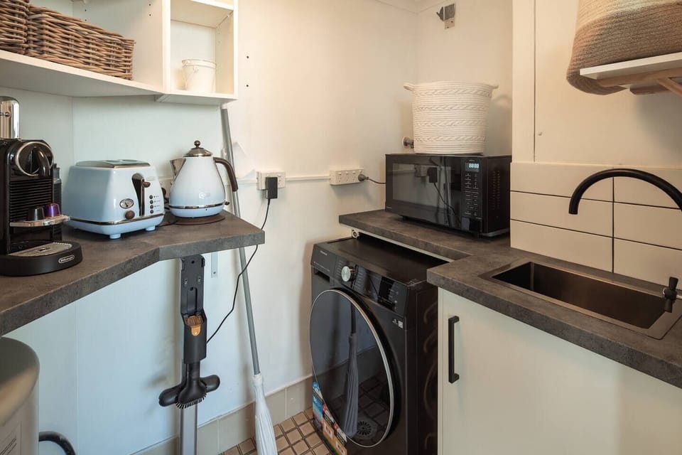 Enjoy the added convenience of in-unit laundry off the kitchen, which also houses kitchen appliances like a toaster, kettle and Nespresso machine.