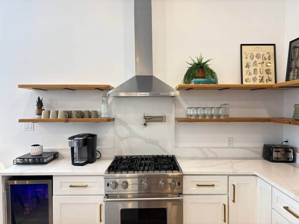 Channel your inner chef in this massive quartz kitchen with high-end chef appliances (Viking range)