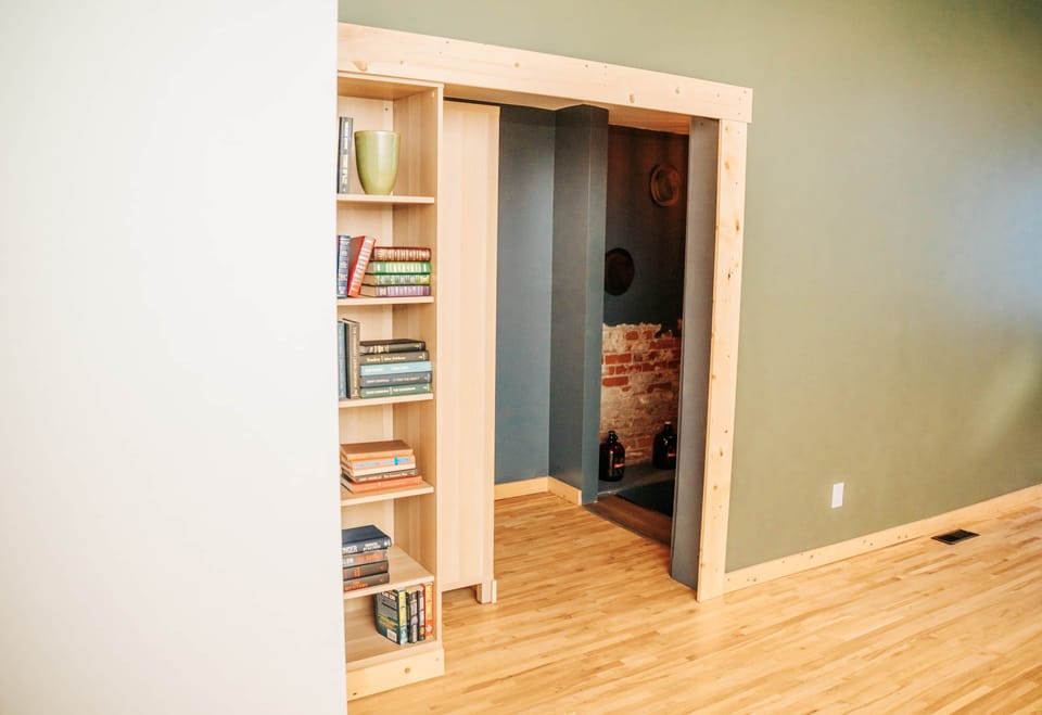 Bookshelf door opens up to reveal hidden 'speakeasy' lounge with theatre and pool table 