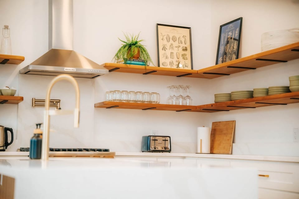 Prepare your masterpieces with large open-concept kitchen with quartz countertops and gold fixtures