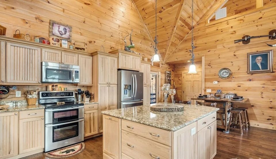 Kitchen: Whip up culinary delights in a charming wood-paneled kitchen with granite counters!

