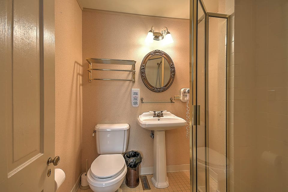 Russell Room private bathroom with walk in shower, grab bar, and optional shower seat.