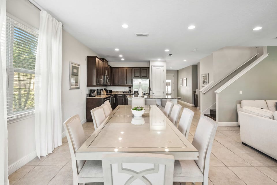 Elegant dining table with seating for the whole group. Great for big meals before and after the parks!