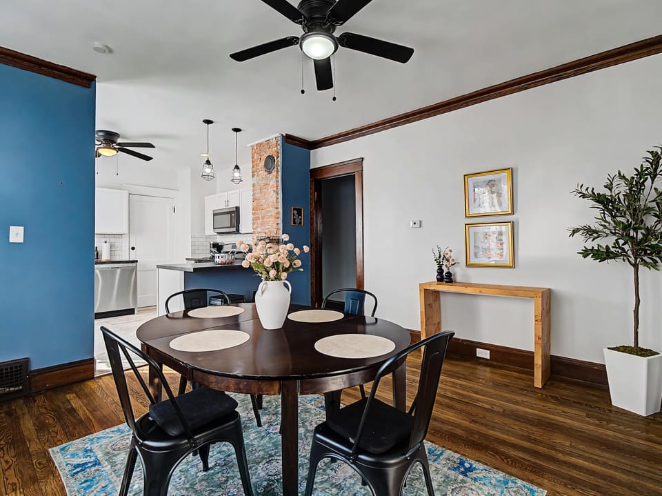 Dining nook w/ blue accent wall & open kitchen access